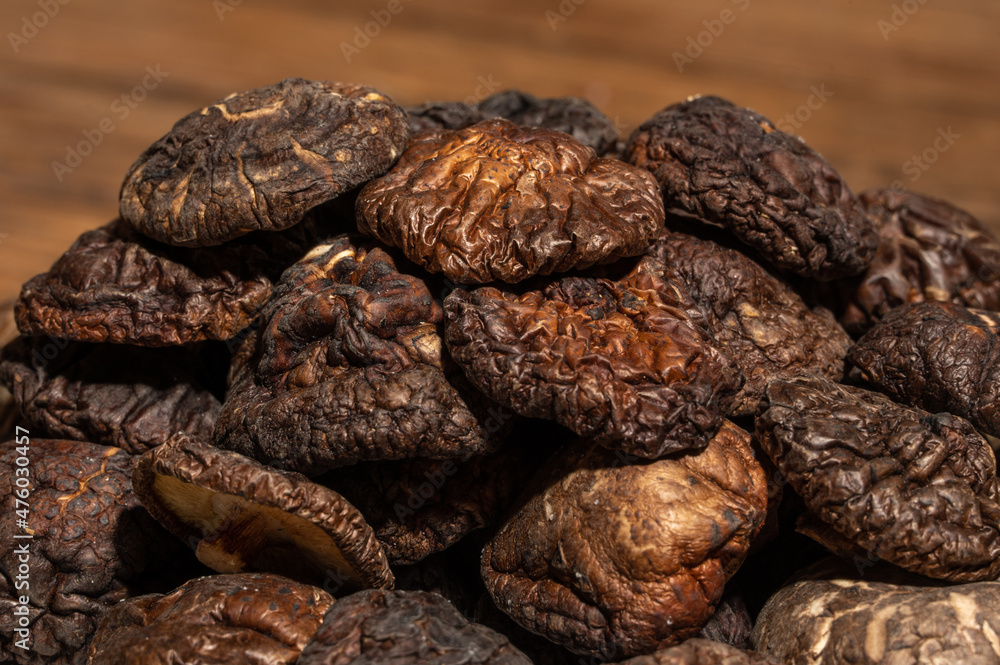 Dried mushrooms in a container on a wooden countertop Dried mushrooms in a container on a wooden countertop
