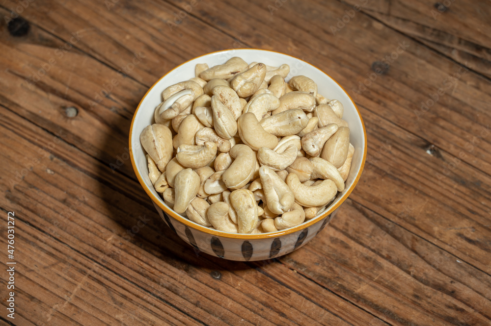 Dried cashew nuts in containers on wooden countertops Dried cashew nuts in containers on wooden countertops