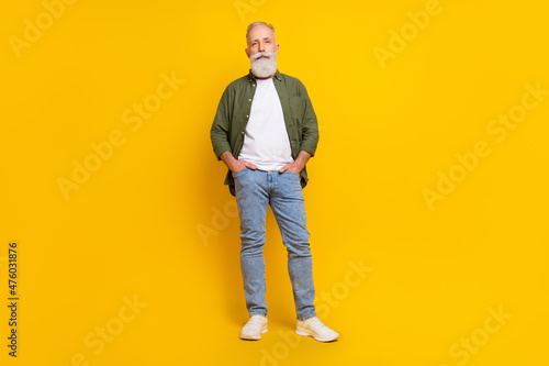 Full length body size photo of senior man serious confident wearing casual outfit isolated vivid yellow color background