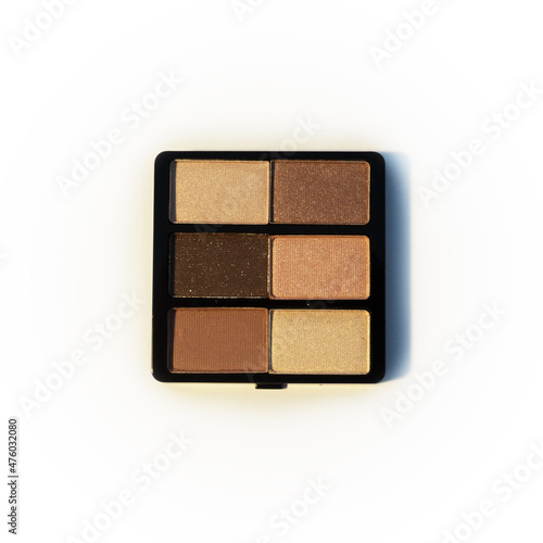 Mini palette of brown and beige eyeshadows. Isolated image on a white background. Nobody.