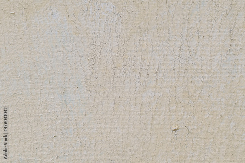 beige old paint on the wall with small cracks