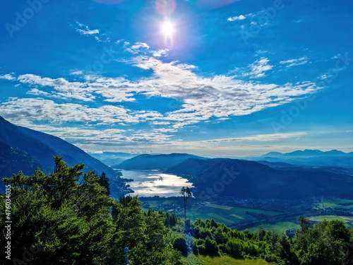 A panoramic view on the Karawanks in Carinhia, Austrian Alps. The mountains in the back are very steep and sharp. The view can be seen from Oswaldiberg, Villach. Clear and blue sky. Serenity photo