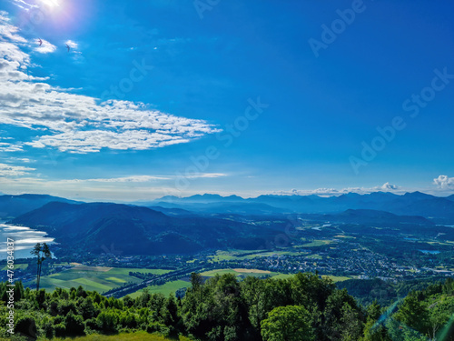 A view on the Lake Ossiach located in the heart of the Alps in Carinthia, Austria. The surface of the lake reflects golden sunbeams. The view is from a chapel on the hilltop of Oswaldiberg.