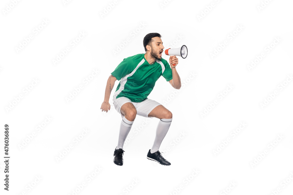 young football player in uniform jumping and screaming in loudspeaker isolated on white. young football player in uniform jumping and screaming in loudspeaker isolated on white.
