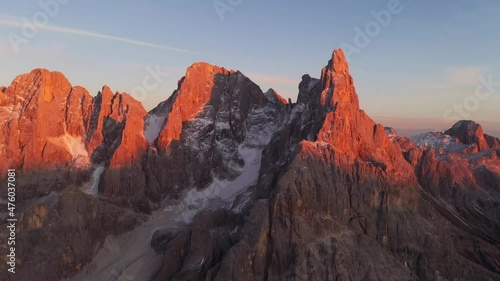 Aerial flight over the Pale di San Martino mountain group in sunset time. Hight mountains with glacier glowing by sunset light. San Martino di Castrozza, Dolomites, Trentino, Italy. photo