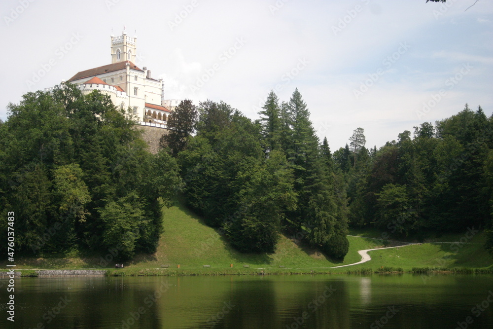 The medieval castle Trakošćan, Varaždin County, Croatia, on the top of the hill surrounded by a forest and a beautiful lake