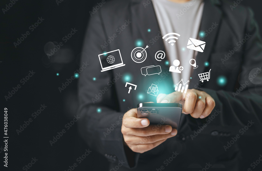 Fototapeta premium Businessman using smartphone, notification social multimedia icons internet connection application digital network marketing online communication.