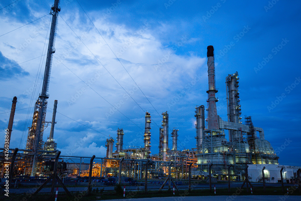 Oil refinery and plant and tower flare fire of Petrochemistry industry in oil and gas industry with cloud blue sky the evening Oil refinery and plant and tower flare fire of Petrochemistry industry in oil and gas industry with cloud blue sky the evening