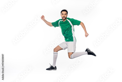 happy young football player in uniform jumping isolated on white.
