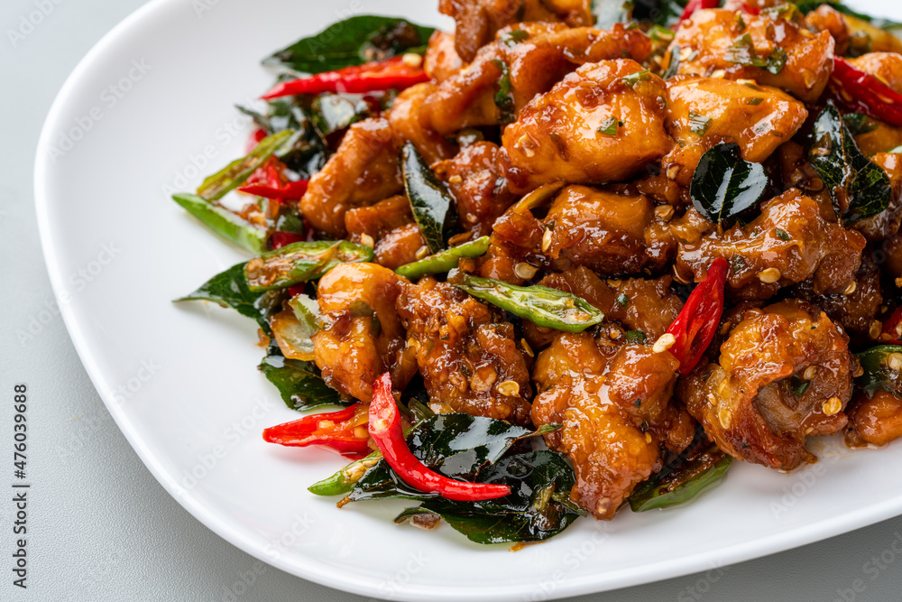 Ayam Tangkap, spices fried chicken original from Aceh, Indonesia. served with leaves such as temurui or curry leaves, pandan leaves and green chili, that are roughly chopped and fried crispy. Ayam Tangkap, spices fried chicken original from Aceh, Indonesia. served with leaves such as temurui or curry leaves, pandan leaves and green chili, that are roughly chopped and fried crispy.