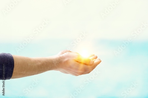 Fotografie, Obraz Jesus Christ near water outdoors, Miraculous light in hand