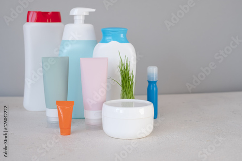 Bottles of cosmetics on a gray background. Mockup, template.