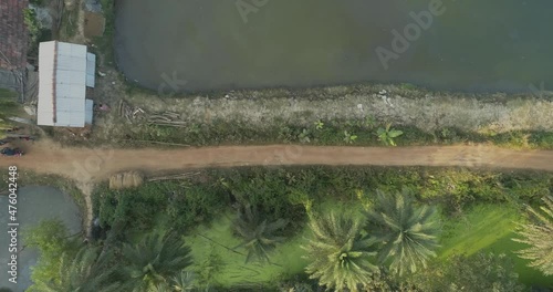 A narrow dirt road that connects a village to a hospital in the remote villages of West Bengal in India photo