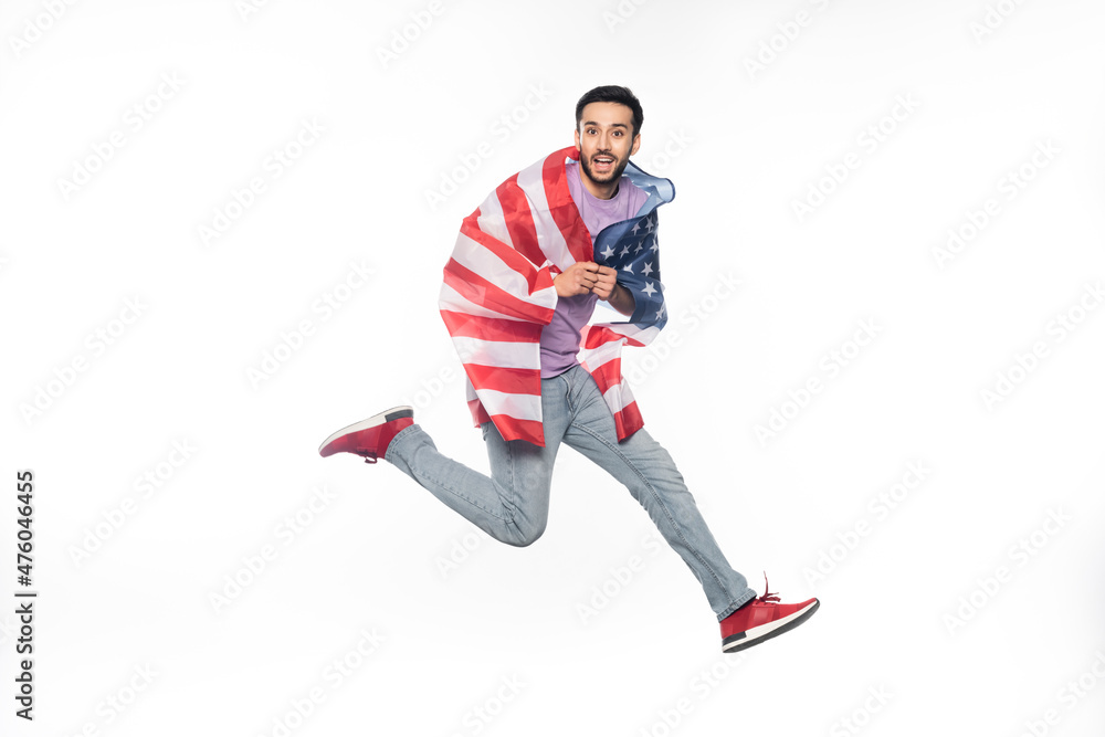happy and patriotic man jumping with american flag isolated on white. happy and patriotic man jumping with american flag isolated on white.