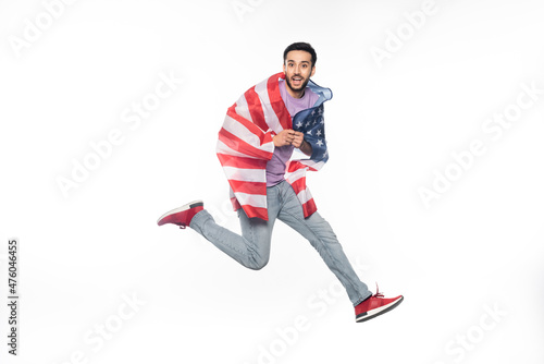 happy and patriotic man jumping with american flag isolated on white.