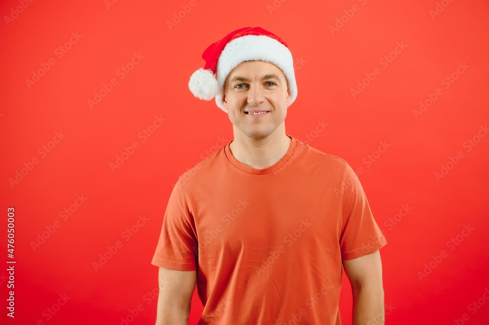 concept people, body language, approval, recommendationan excited man Santa Claus hat isolated on red studio background with space for text