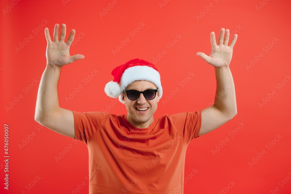 Portrait of happy and excited man in santa hat, rejoicing and winning something, celebrating new year, standing over red background Portrait of happy and excited man in santa hat, rejoicing and winning something, celebrating new year, standing over red background