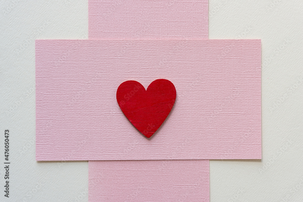 isolated grungy red heart on pink paper isolated grungy red heart on pink paper