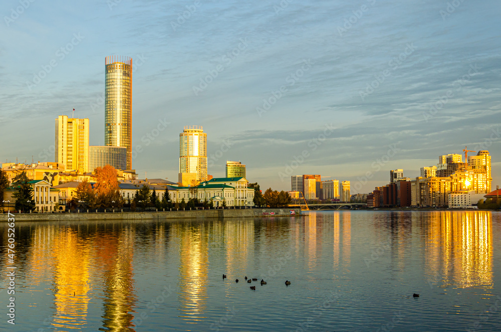 High-rise buildings on the shore of the lake at dawn.
