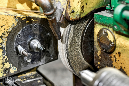 On the old machine in the workshop there is a disc for grinding metal parts.