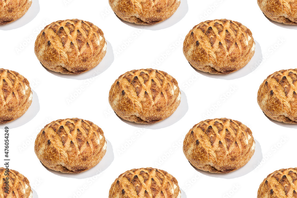 Seamless repetitive pattern loafs of freshly baked wheat bread on white background. Minimal food background. Seamless repetitive pattern loafs of freshly baked wheat bread on white background. Minimal food background.