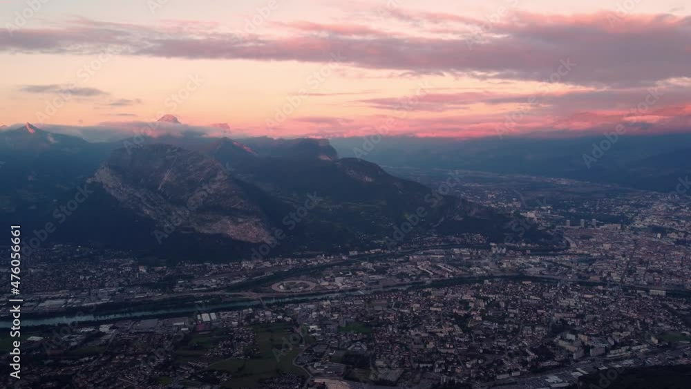 Grenoble city in France. Beautiful panning shot of the sunset over the mountains under the red cloudy sky. Shot during the evening in 4k. Grenoble city in France. Beautiful panning shot of the sunset over the mountains under the red cloudy sky. Shot during the evening in 4k.