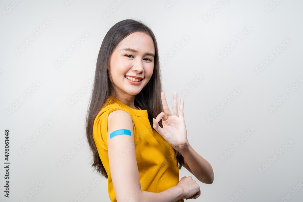 Portrait of pretty, beautiful asian young, teenage attractive after getting, receive anti virus vaccine covid-19. Showing arm on white bandage isolated on white background, copy space. Portrait of pretty, beautiful asian young, teenage attractive after getting, receive anti virus vaccine covid-19. Showing arm on white bandage isolated on white background, copy space.