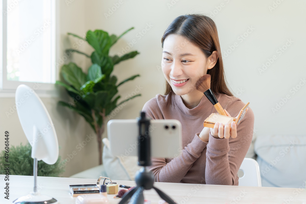 Beauty blogger, asian young woman, girl vlogger makeup face, showing, reviews cosmetics products while recording video, tutorial to share on social media. Business online influencer on smartphone. Beauty blogger, asian young woman, girl vlogger makeup face, showing, reviews cosmetics products while recording video, tutorial to share on social media. Business online influencer on smartphone.