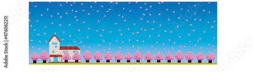 桜舞う春の青空と校舎