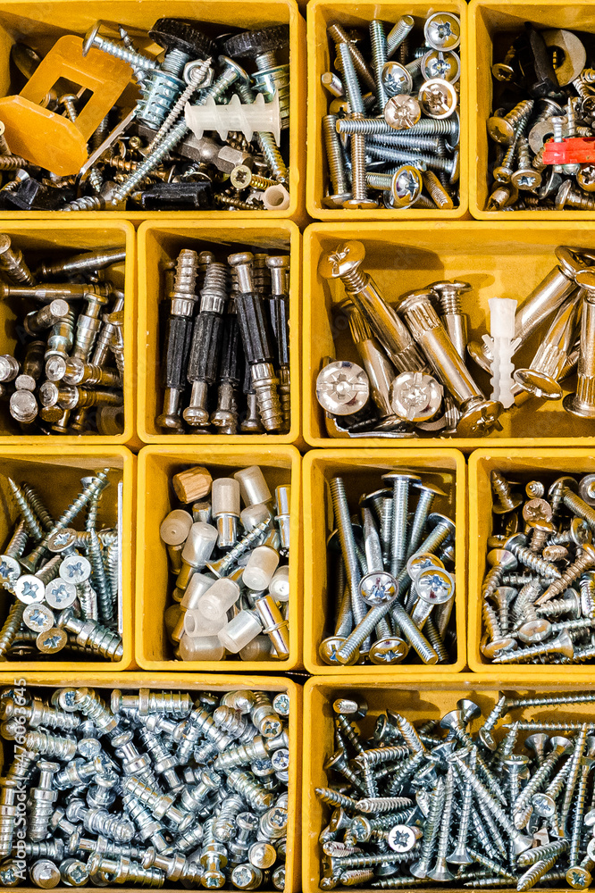 Yellow case with small construction objects. Arranged neatly and organized