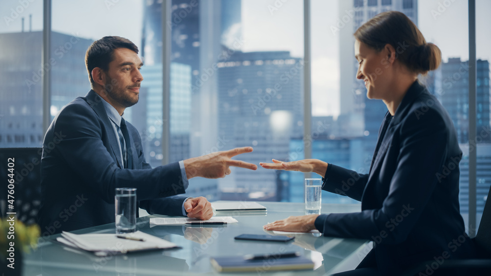 Female and Male Business Partners Have Fun and Play Rock Paper Scissors while Meeting Discussing Corporate Strategy, Financial Reports and Marketing Projects. Corporate Decisions Rely on Chance. Female and Male Business Partners Have Fun and Play Rock Paper Scissors while Meeting Discussing Corporate Strategy, Financial Reports and Marketing Projects. Corporate Decisions Rely on Chance.