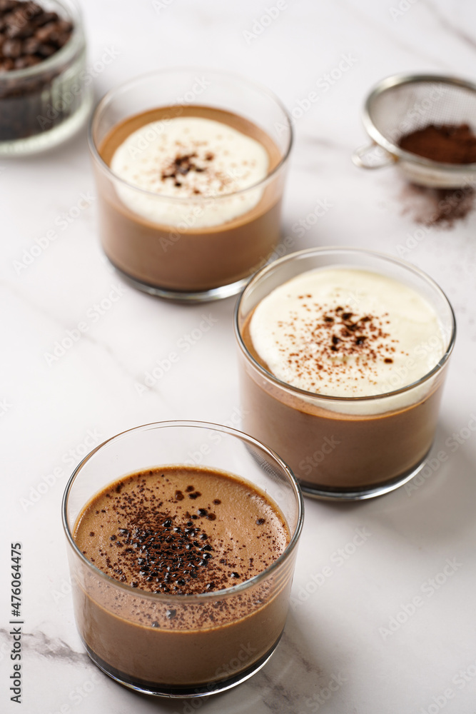 Italian chocolate and coffee mousse dessert semifreddo - half-frozen ice cream with whipped cream and cocoa powder in small glasses Italian chocolate and coffee mousse dessert semifreddo - half-frozen ice cream with whipped cream and cocoa powder in small glasses