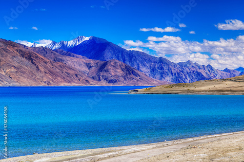 Blue water of Pangong tso (Lake). It is huge lake in Ladakh, shared by China and India along India China LOC border, Himalayan mountains alonside from India to Tibet. Leh, Ladakh, Kashmir, India