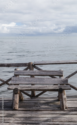 Old wooden bench stands at the pier