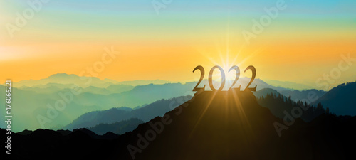 Fotografie, Obraz Landscape background banner panorama 2022 - Breathtaking view with black silhouette of mountains, hills and forest ( Black forest ), in the evening during the sunset, with a brightly colored sky