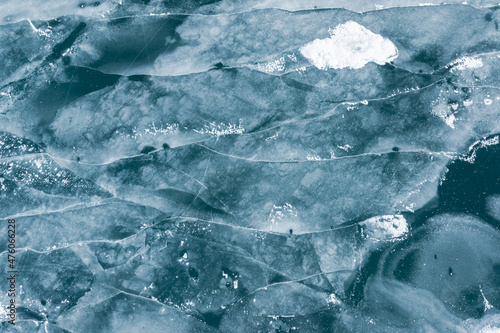 winter texture drone shot of ice cracks on a frozen lake