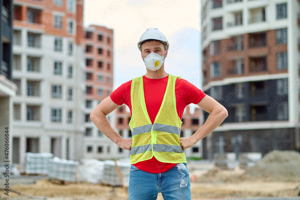 Man standing at construction site looking at camera Man standing at construction site looking at camera