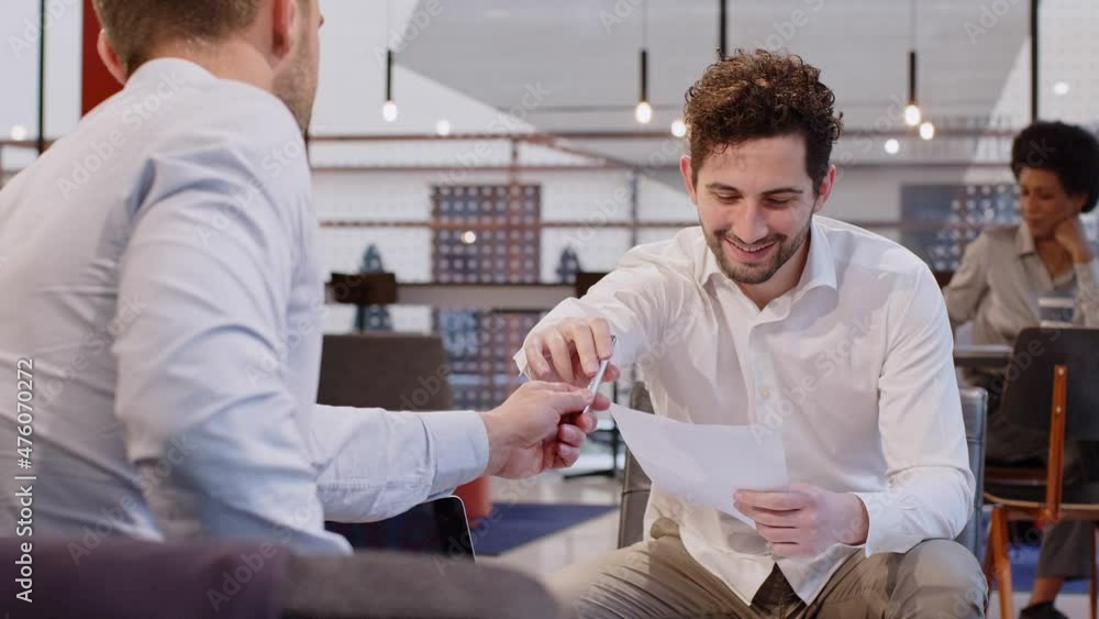 Businessmen discussing contract sitting in office Businessmen discussing contract sitting in office