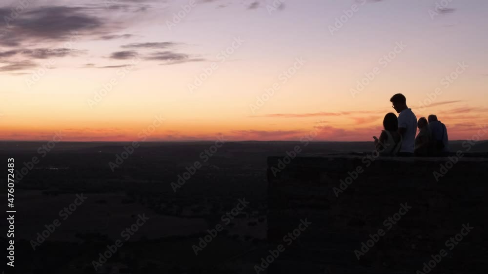 Silhouette of tourists watching the sunset at the horizon of Monsaraz Castle. Silhouette of tourists watching the sunset at the horizon of Monsaraz Castle.