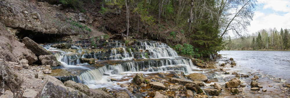 Fototapeta premium the waterfall emanating from under ground on the river Poneretka