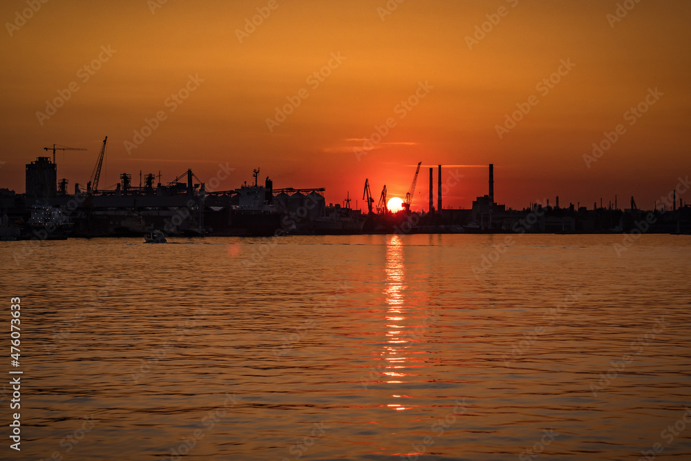 sunset over industrial port