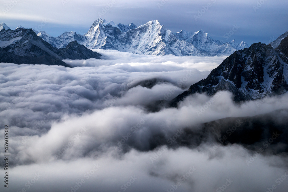 Nepal, Himalayas, sunrise view from Gokio Ri peak at cloud sea over Gokio valley and mountains Tamserku and Kangtega. 