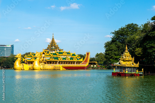 Yangon, Myanmar - view of Karaweik Palace reflected on the waters of Kandawgyi Lake photo