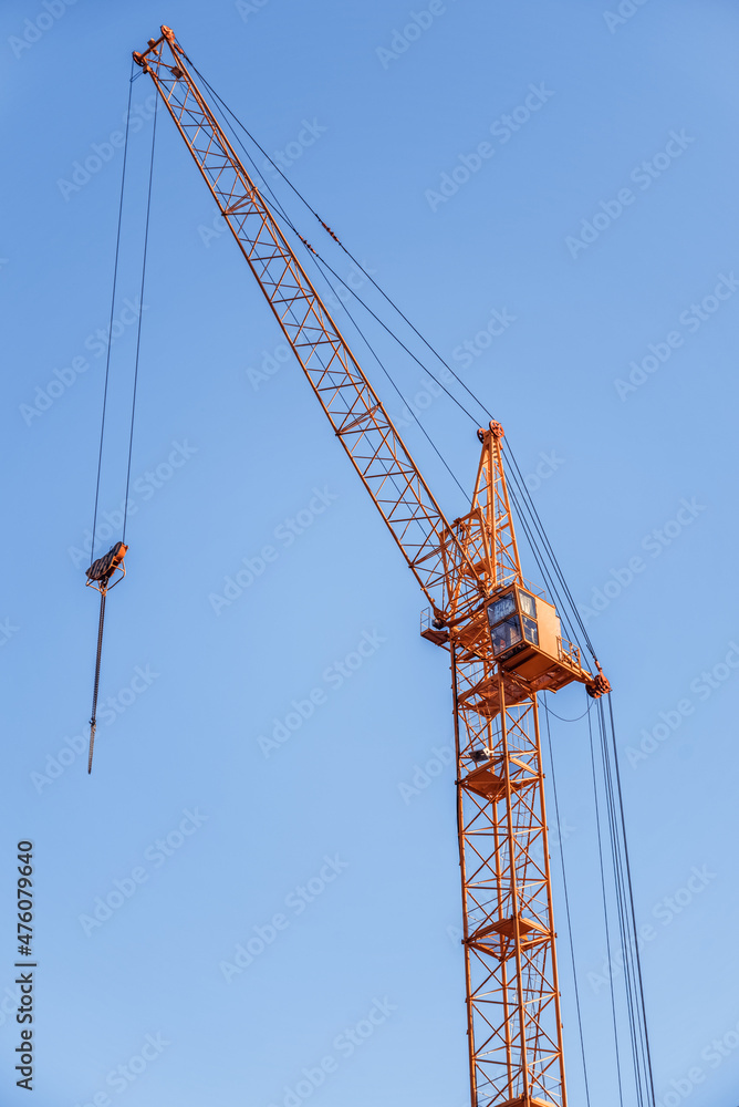 Construction crane. Red construction crane against a clear sky. Construction crane. Red construction crane against a clear sky.