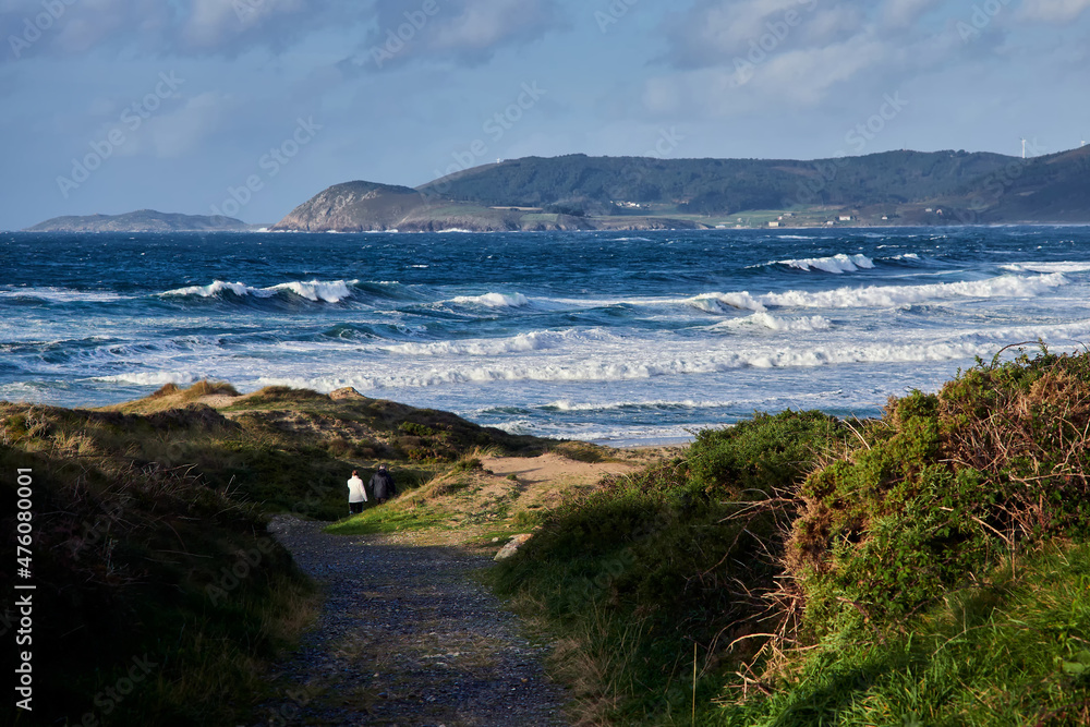 Hiking in Rostro beach in Finisterre, Galicia, Spain. This wild beach and one of the surfer's paradises in the region of Costa da Morte