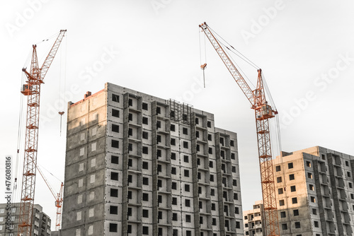 Construction site with cranes on sky background