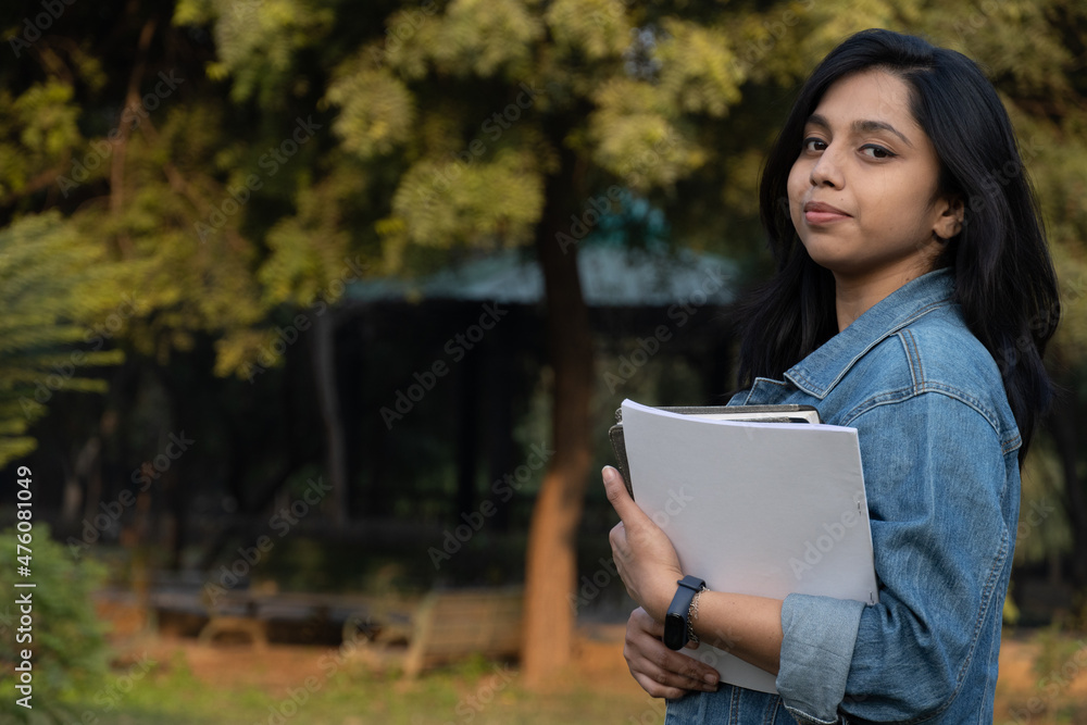 Beautiful Indian female having books in college Beautiful Indian female having books in college