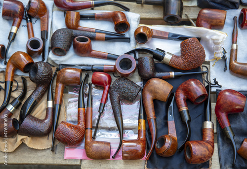 Fotografie Top view of many smoking tobacco pipes in a market
