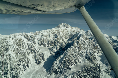 Beautiful snow covered mountains seen from small airplane