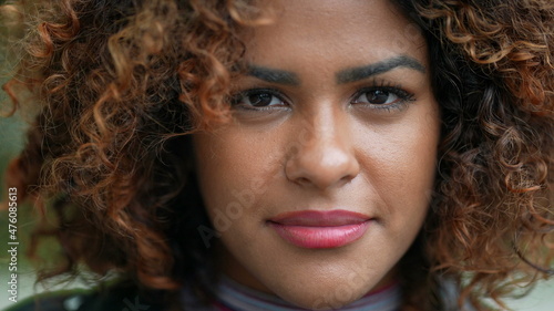 Confident Brazilian black woman walking forward to camera. portrait face close-up smiling
